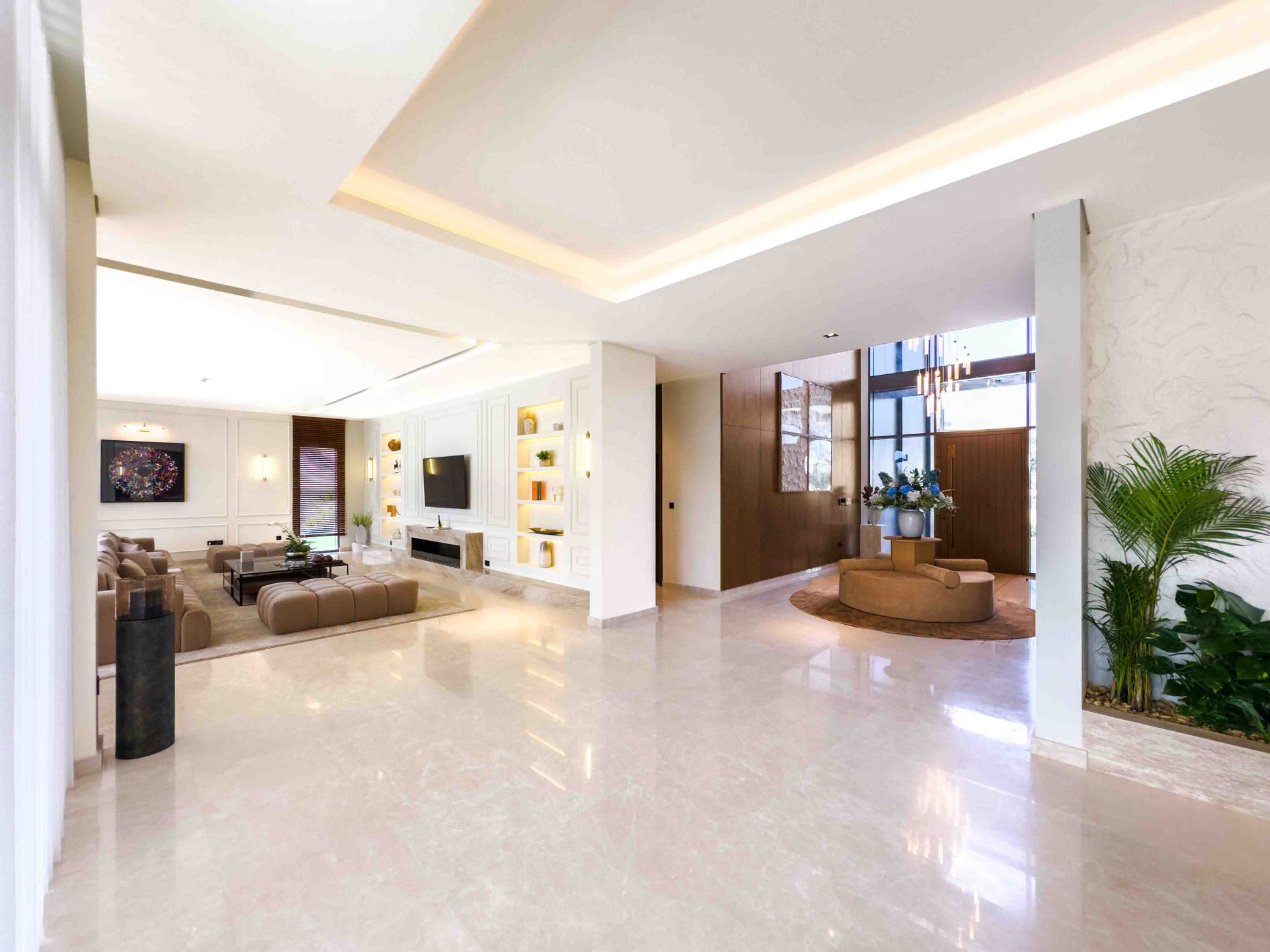 Open-plan ground floor connecting the living room and double-height entrance foyer