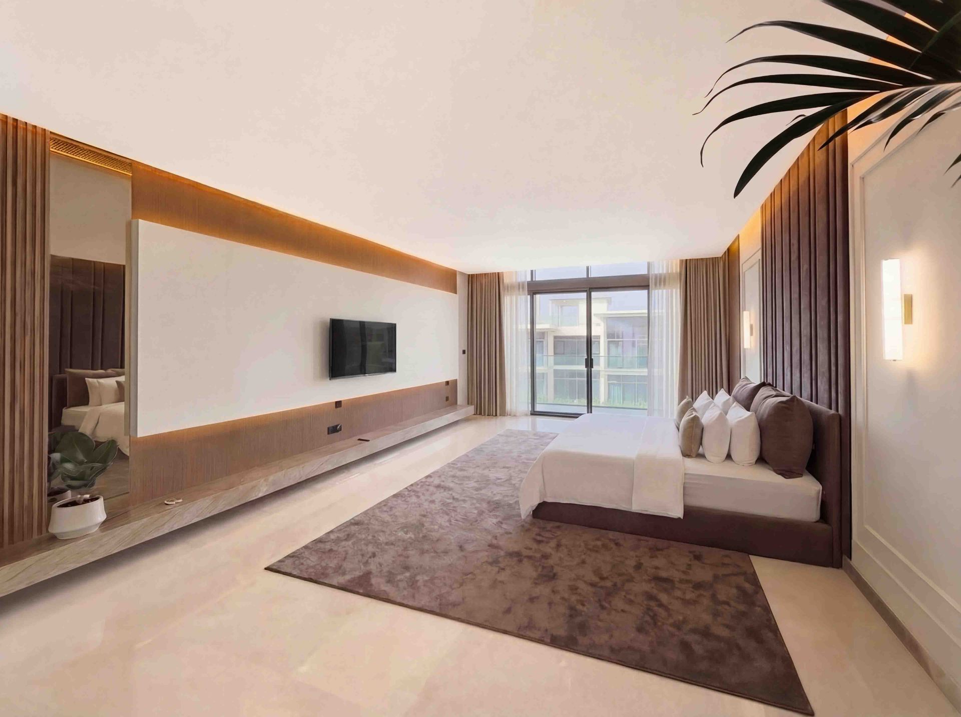 Primary bedroom with mirrored wall, floating TV console and floor-to-ceiling sheers
