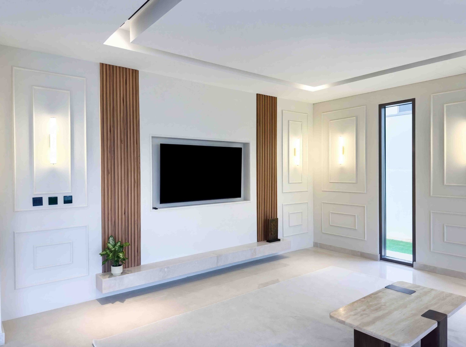 Formal living room with panelled walls, fluted timber accents and recessed TV niche
