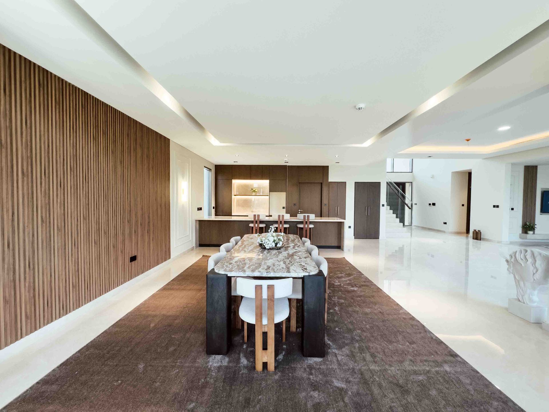 Open-plan ground floor connecting the dining area, kitchen and staircase